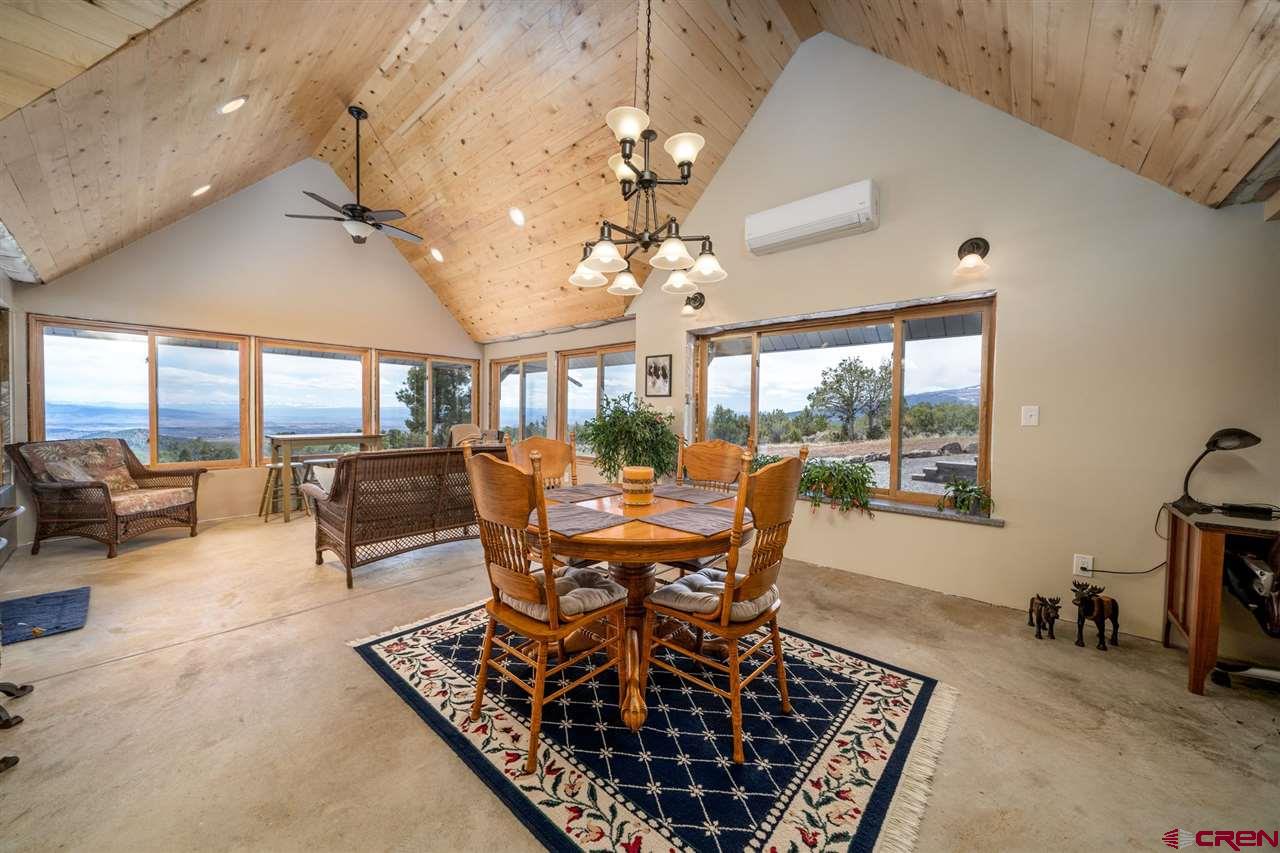 20885 Mesawood Road Cedaredge, CO 81413 - Photo 15 of 35 a view of a dining room with furniture window and outside view