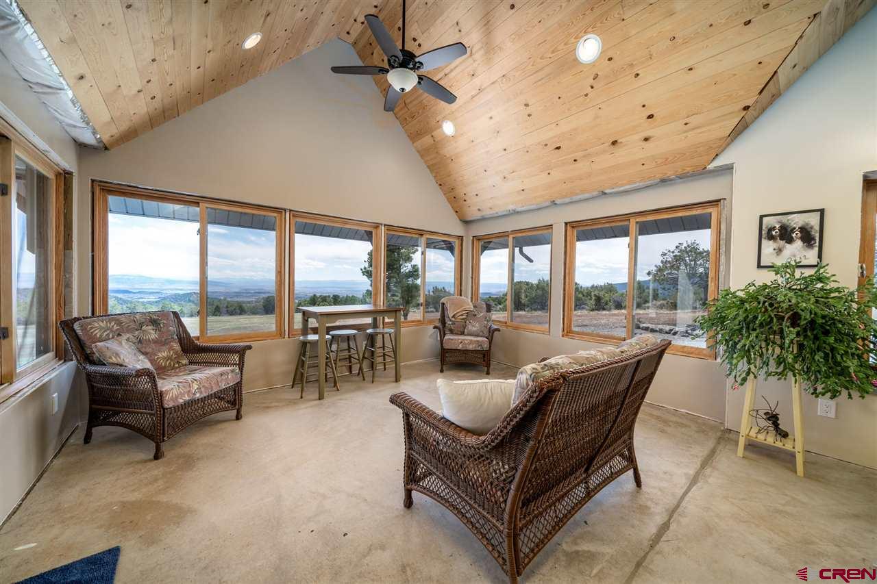 20885 Mesawood Road Cedaredge, CO 81413 - Photo 17 of 35 a living room with furniture and a large window