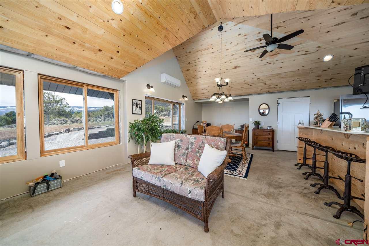 20885 Mesawood Road Cedaredge, CO 81413 - Photo 18 of 35 a living room with furniture and a large window