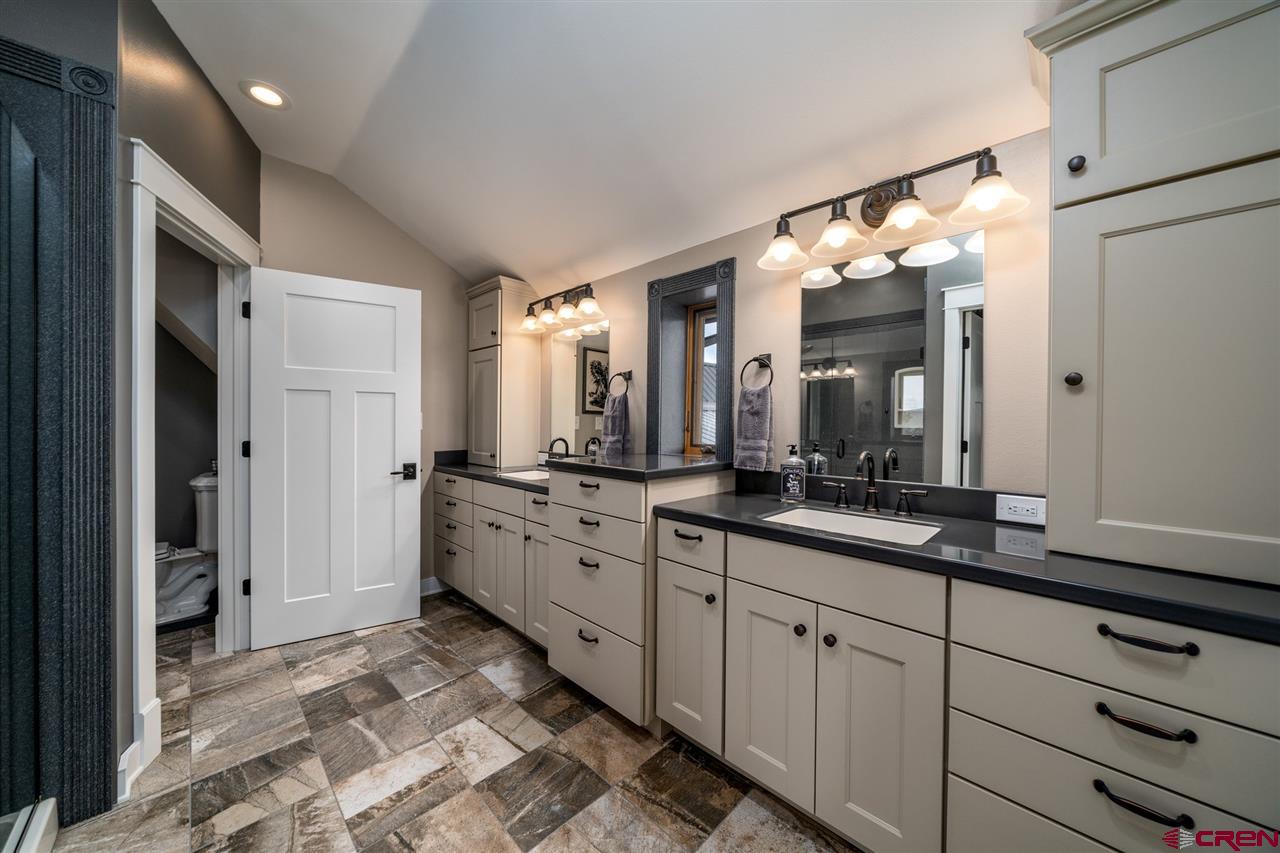 20885 Mesawood Road Cedaredge, CO 81413 - Photo 28 of 35 a large bathroom with a double vanity sink and a mirror