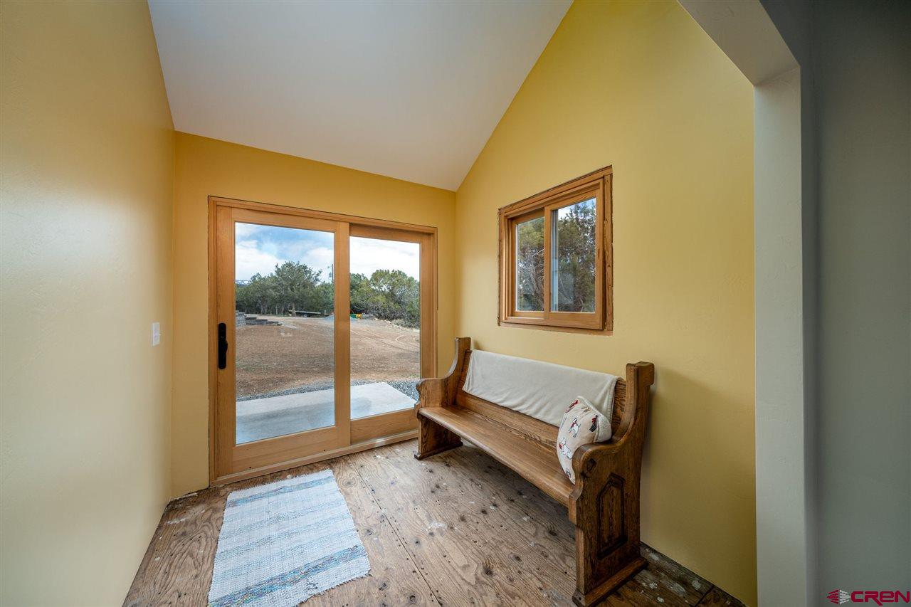 20885 Mesawood Road Cedaredge, CO 81413 - Photo 4 of 35 a bedroom with a bed and wooden floor