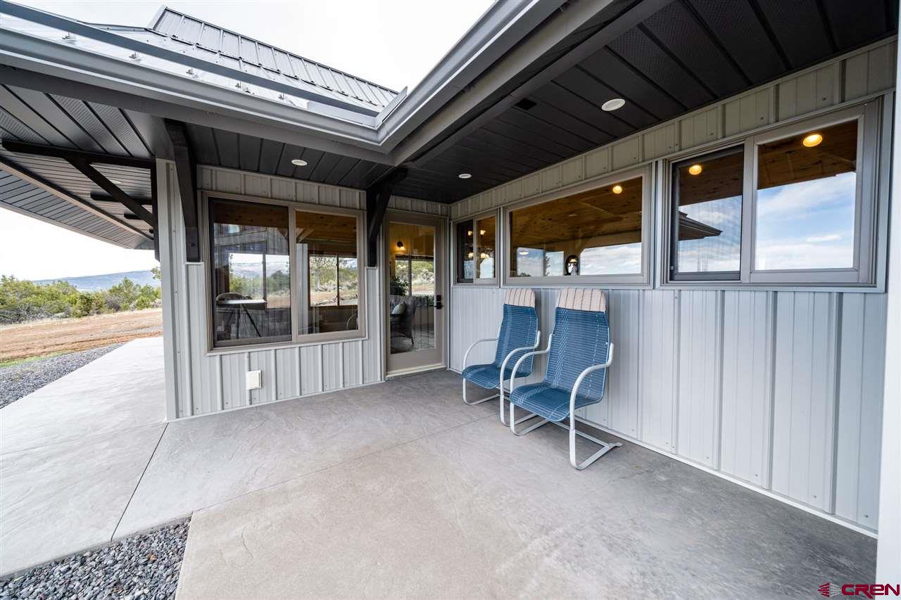 20885 Mesawood Road Cedaredge, CO 81413 - Photo 33 of 35 a view of a patio with table and chairs