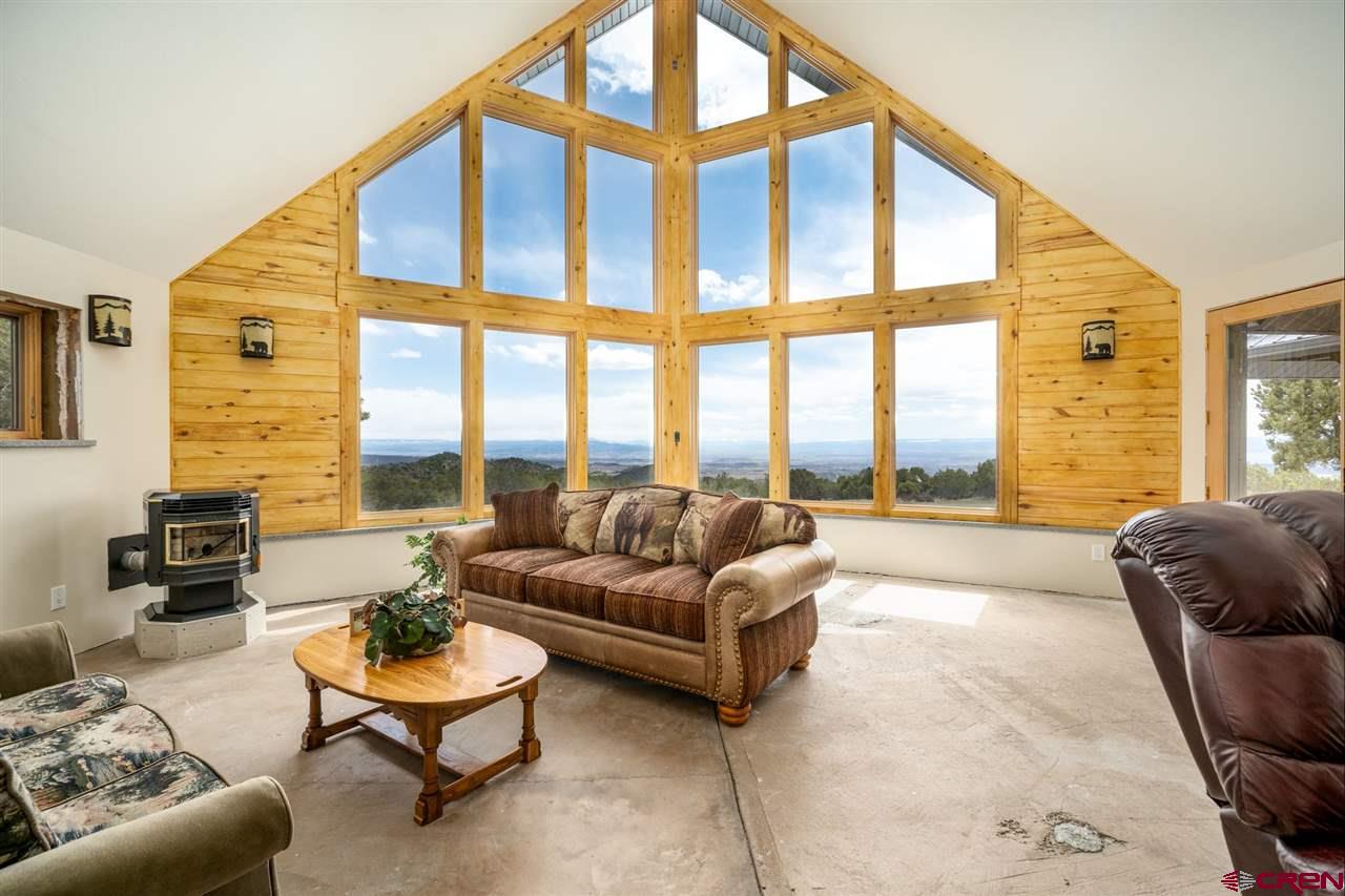 20885 Mesawood Road Cedaredge, CO 81413 - Photo 5 of 35 a living room with furniture and a large window
