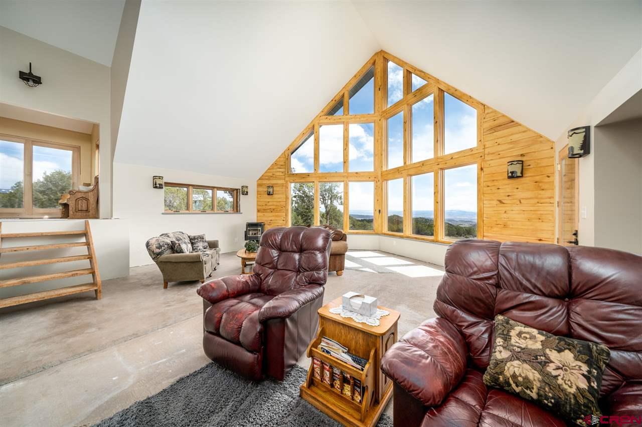 20885 Mesawood Road Cedaredge, CO 81413 - Photo 6 of 35 a living room with furniture and a large window