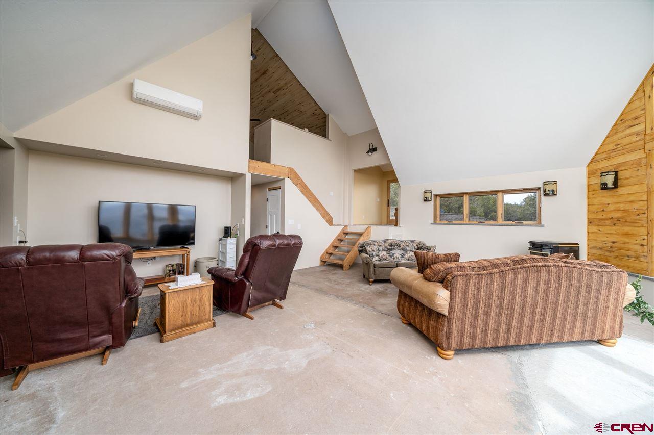 20885 Mesawood Road Cedaredge, CO 81413 - Photo 7 of 35 a living room with furniture and a flat screen tv