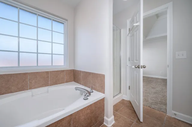 a bathroom with a tub and shower