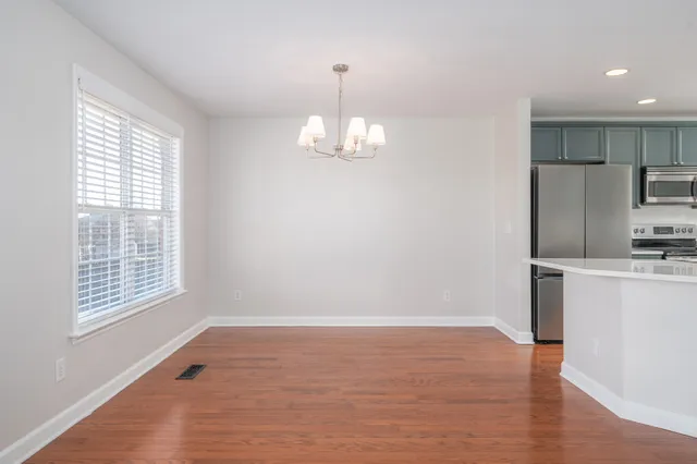 a view of a kitchen with a dishwasher cabinets and a window