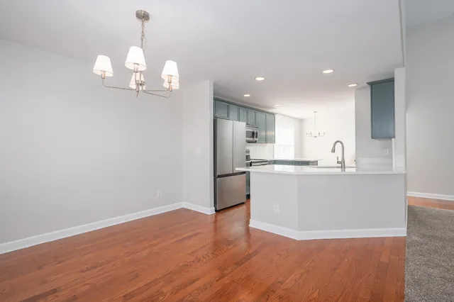 a view of a kitchen with a sink wooden floor and a kitchen view