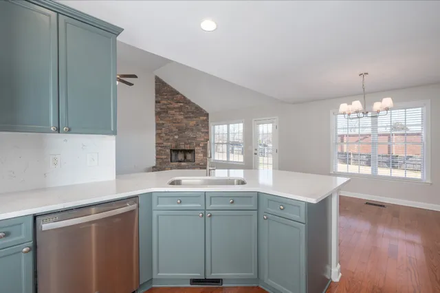 a kitchen with a sink cabinets and window