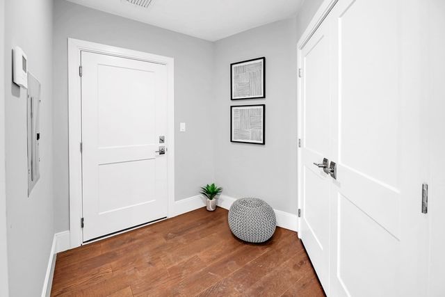 a view of a room with wooden floor and cabinet