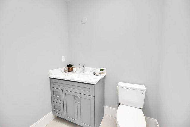 a bathroom with a sink a toilet and a mirror