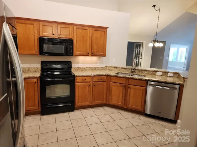 a kitchen with a sink and a stove top oven