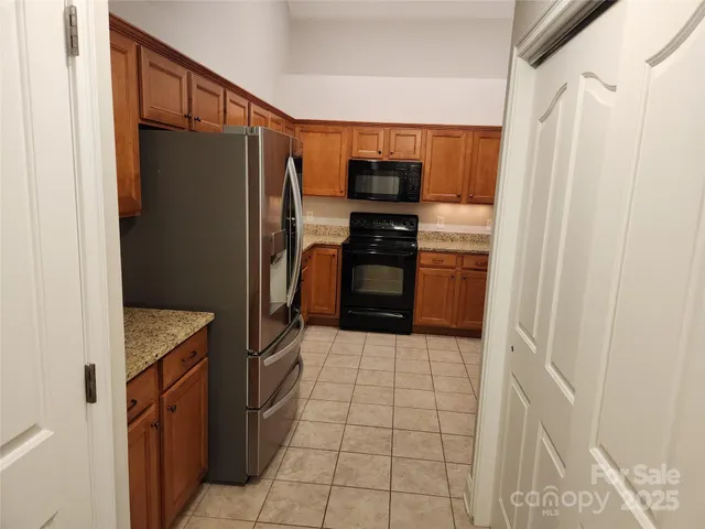 a kitchen with stainless steel appliances a refrigerator and a stove