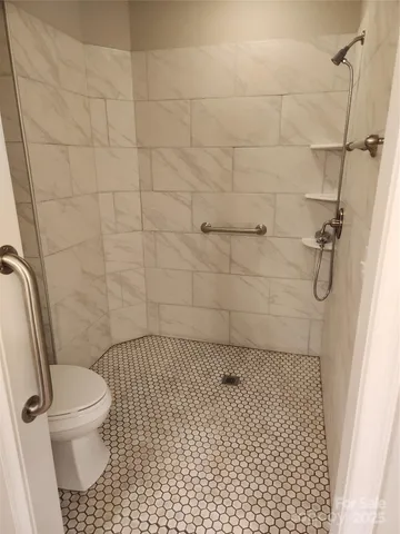 a view of closet with wooden floor and stairs