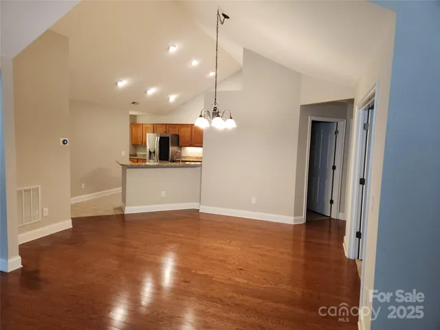 a view of a kitchen with a sink and dishwasher wooden floor