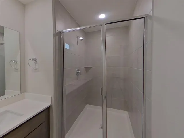 a bathroom with a shower and a sink