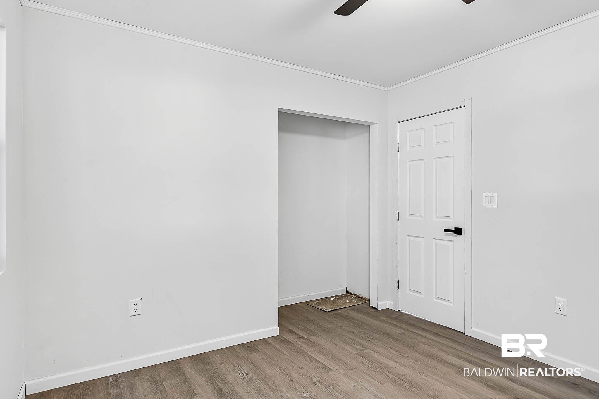 101 Terry Avenue Brewton, AL 36426 - Photo 43 of 48 Unfurnished bedroom featuring wood finished floors, a ceiling fan, and ornamental molding