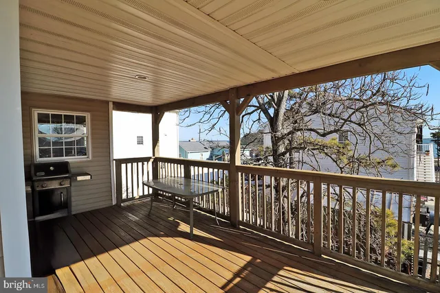 a view of a balcony with wooden floor