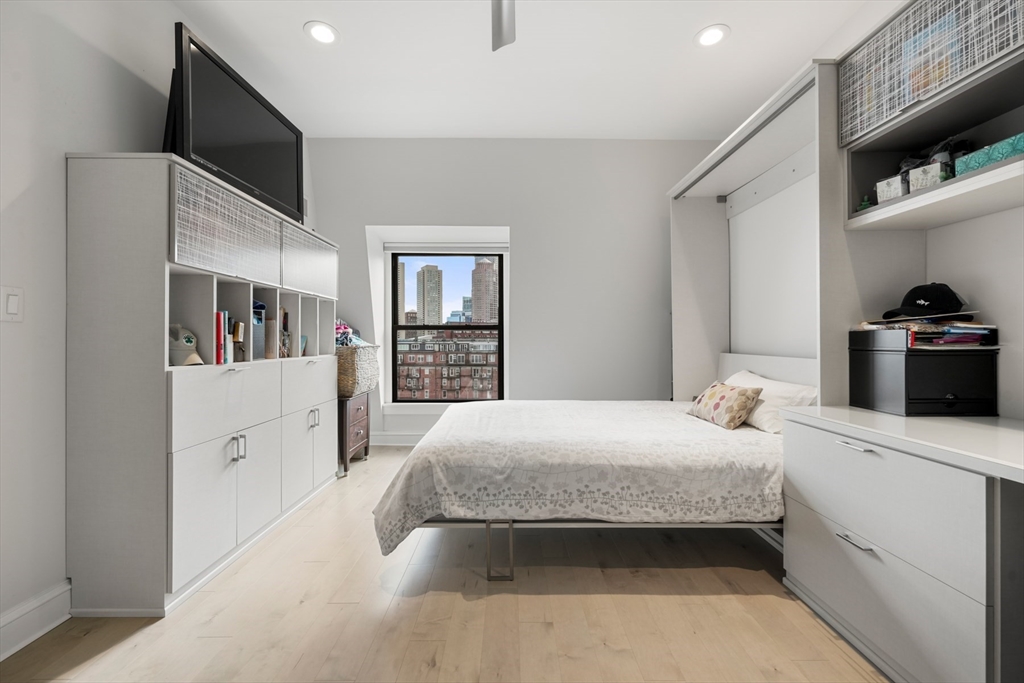 28 Atlantic Avenue, Unit 638 Boston, MA 02110 - Photo 23 of 39 a bedroom with a large bed and a flat tv screen