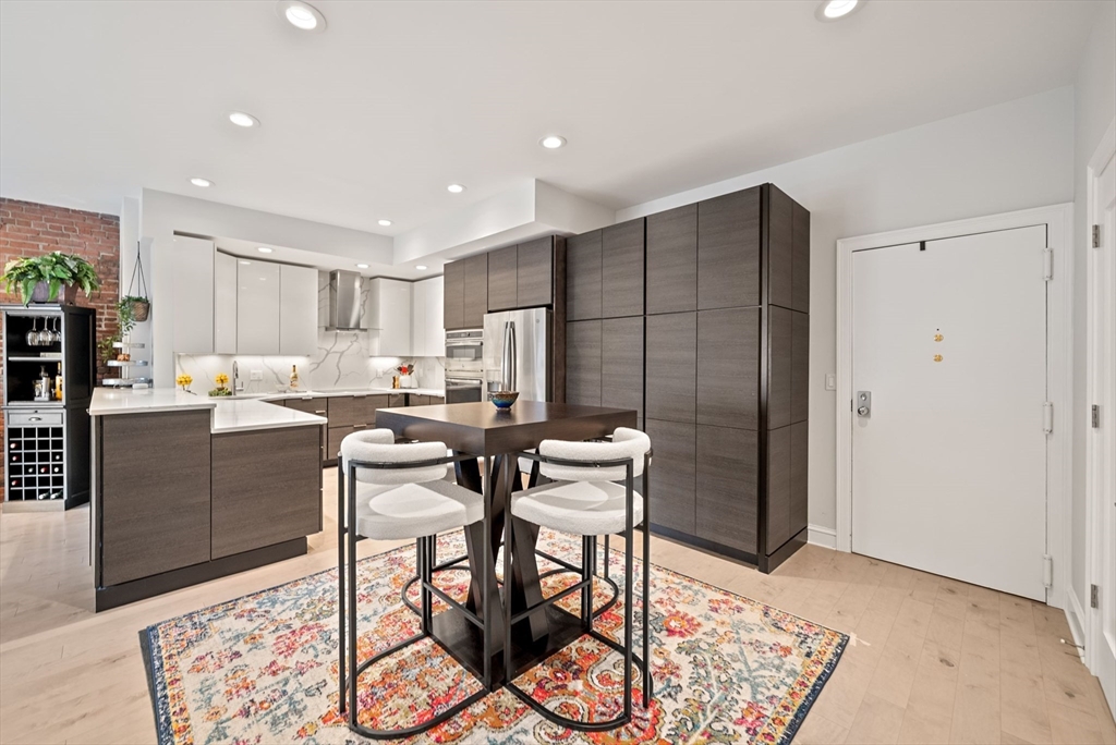 28 Atlantic Avenue, Unit 638 Boston, MA 02110 - Photo 3 of 39 a kitchen with stainless steel appliances granite countertop a refrigerator and a stove top oven