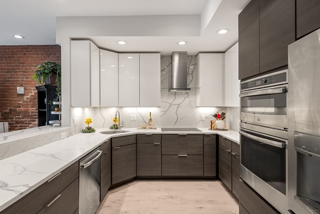 28 Atlantic Avenue, Unit 638 Boston, MA 02110 - Photo 5 of 39 a kitchen with a sink and stainless steel appliances