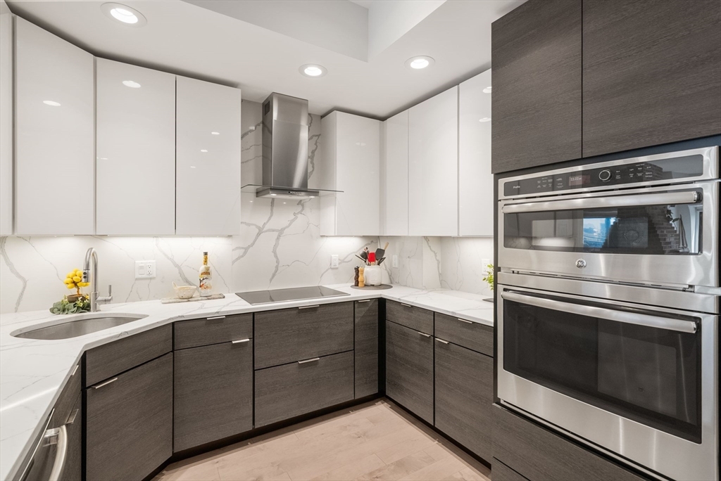 28 Atlantic Avenue, Unit 638 Boston, MA 02110 - Photo 7 of 39 a kitchen with a sink and cabinets