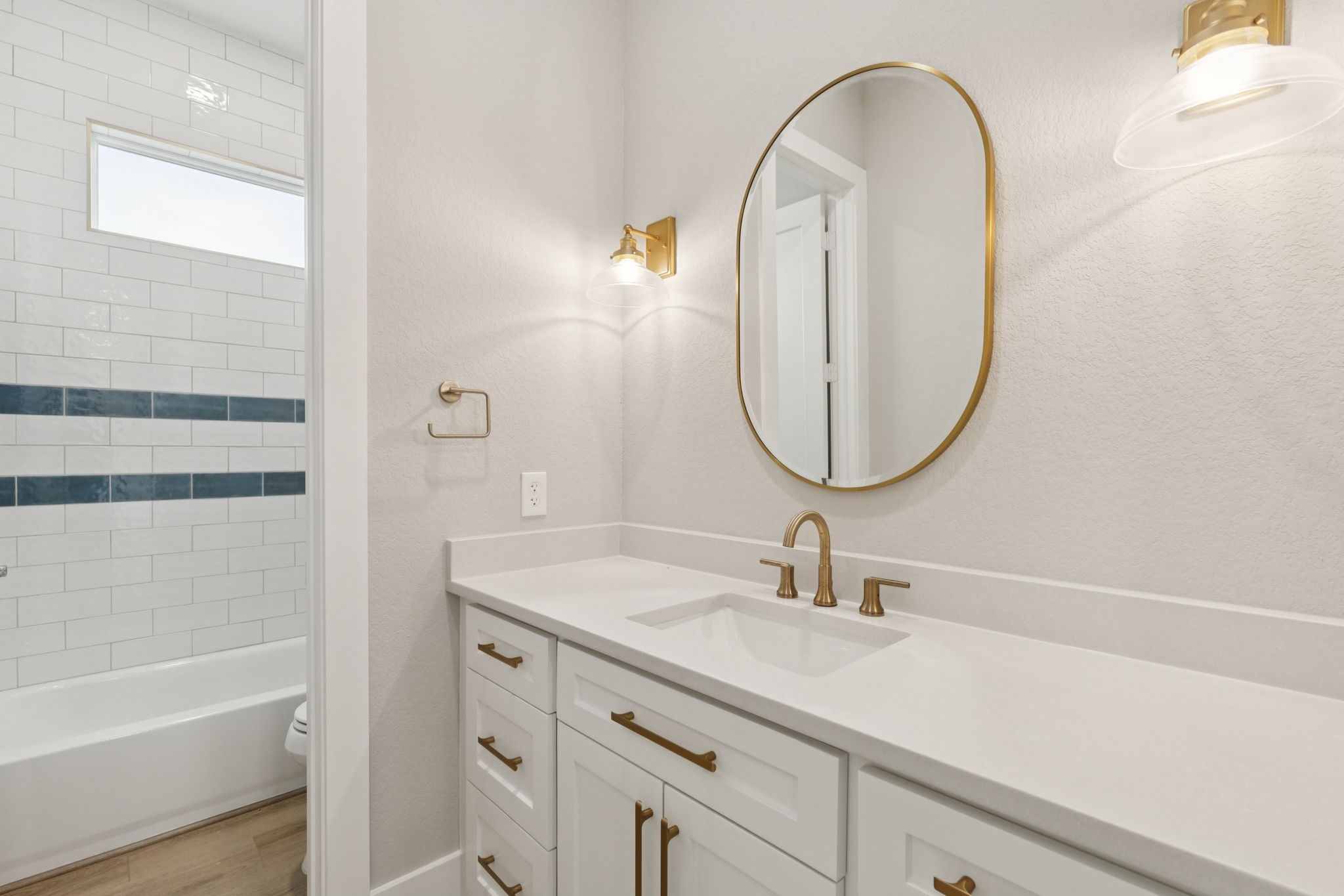 591 Pompano Lane Freeport, TX 77541 - Photo 12 of 23 a bathroom with a sink a mirror a vanity and a bathtub
