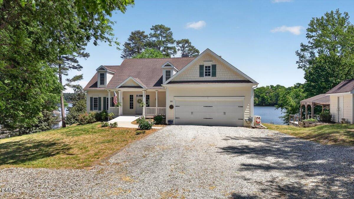 a front view of a house with a yard outdoor seating and trees