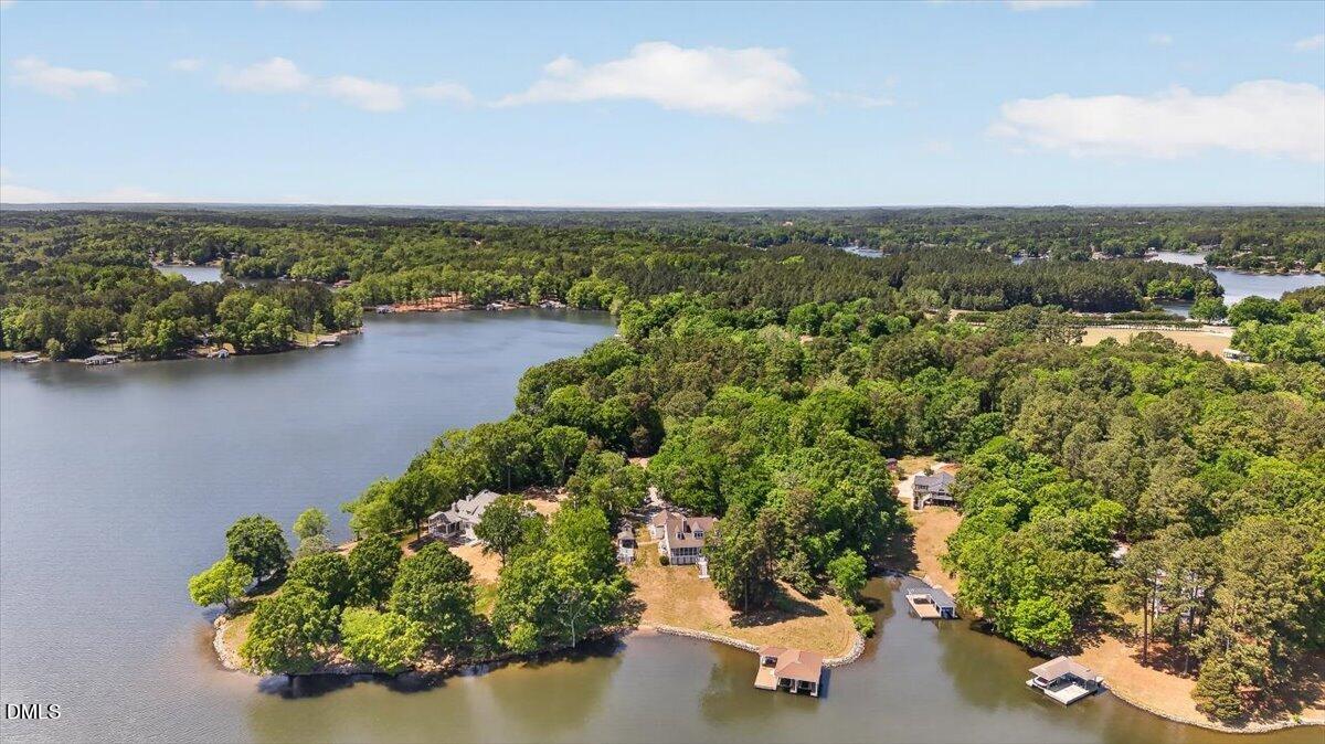 185 Joe Baldwin Road Leasburg, NC 27291 - Photo 8 of 95 an aerial view of a city with lots of residential buildings ocean and mountain view in back