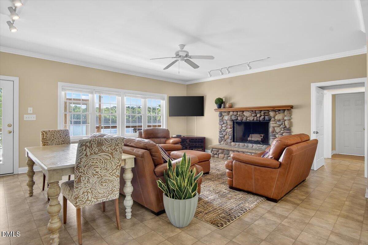 185 Joe Baldwin Road Leasburg, NC 27291 - Photo 11 of 95 a living room with furniture a fireplace and a flat screen tv