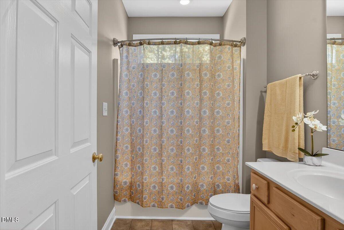 185 Joe Baldwin Road Leasburg, NC 27291 - Photo 23 of 95 a bathroom with a granite countertop sink toilet and shower