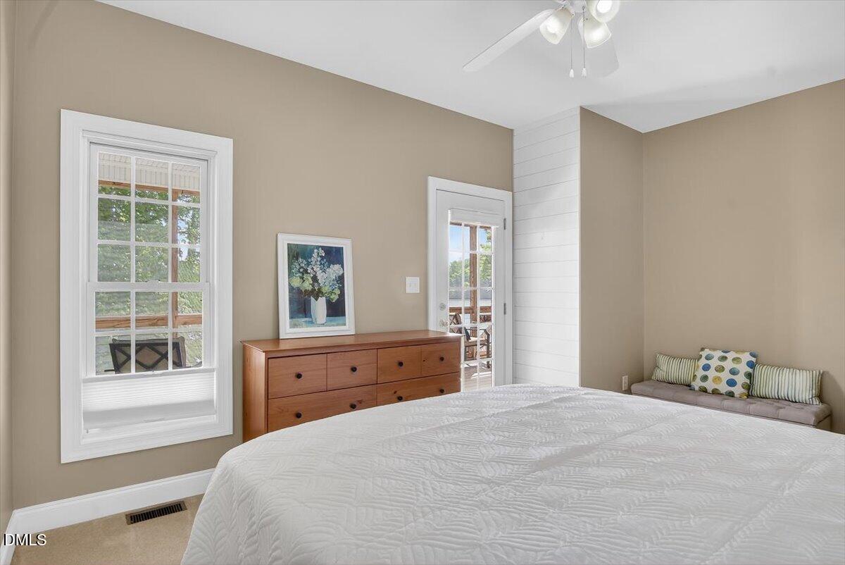 185 Joe Baldwin Road Leasburg, NC 27291 - Photo 27 of 95 a bedroom with a bed dresser and wooden floor