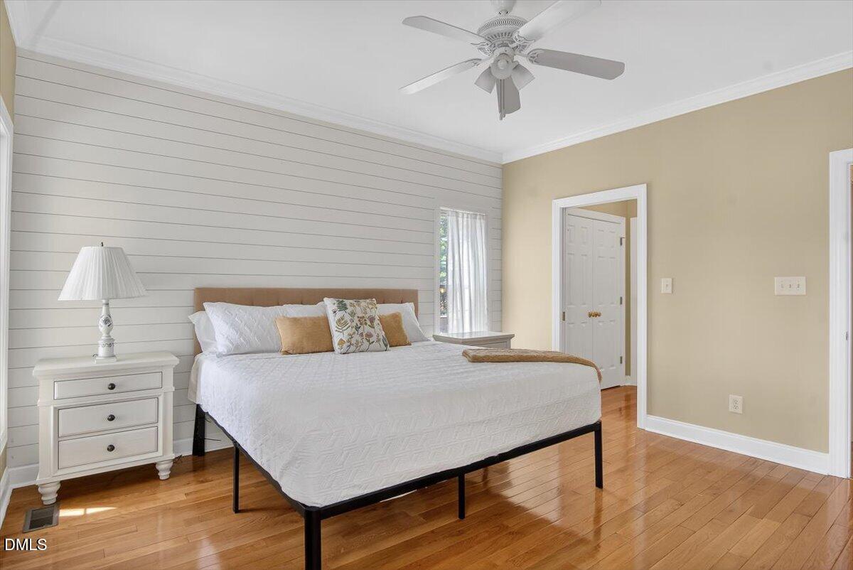 185 Joe Baldwin Road Leasburg, NC 27291 - Photo 29 of 95 a bedroom with a bed and a chandelier
