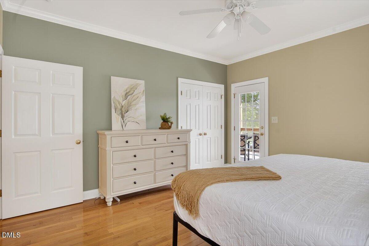 185 Joe Baldwin Road Leasburg, NC 27291 - Photo 32 of 95 a bedroom with a bed and a chandelier