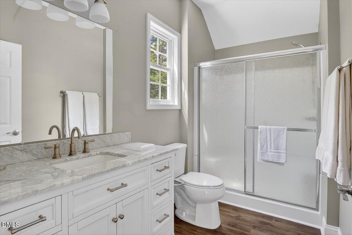 185 Joe Baldwin Road Leasburg, NC 27291 - Photo 40 of 95 a bathroom with a granite countertop sink toilet and shower