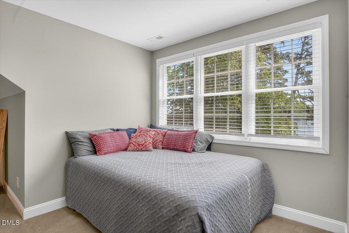 185 Joe Baldwin Road Leasburg, NC 27291 - Photo 42 of 95 a bedroom with a bed and a large window
