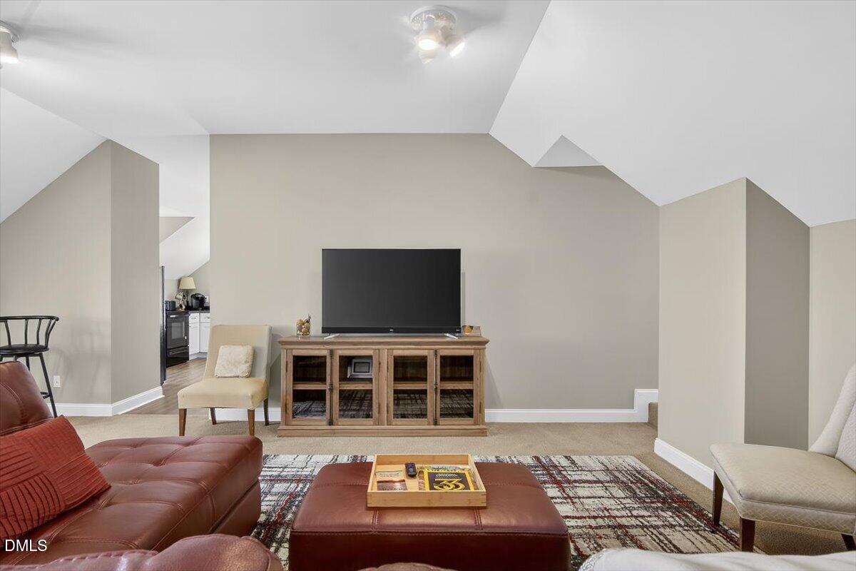 185 Joe Baldwin Road Leasburg, NC 27291 - Photo 44 of 95 a living room with furniture and a flat screen tv