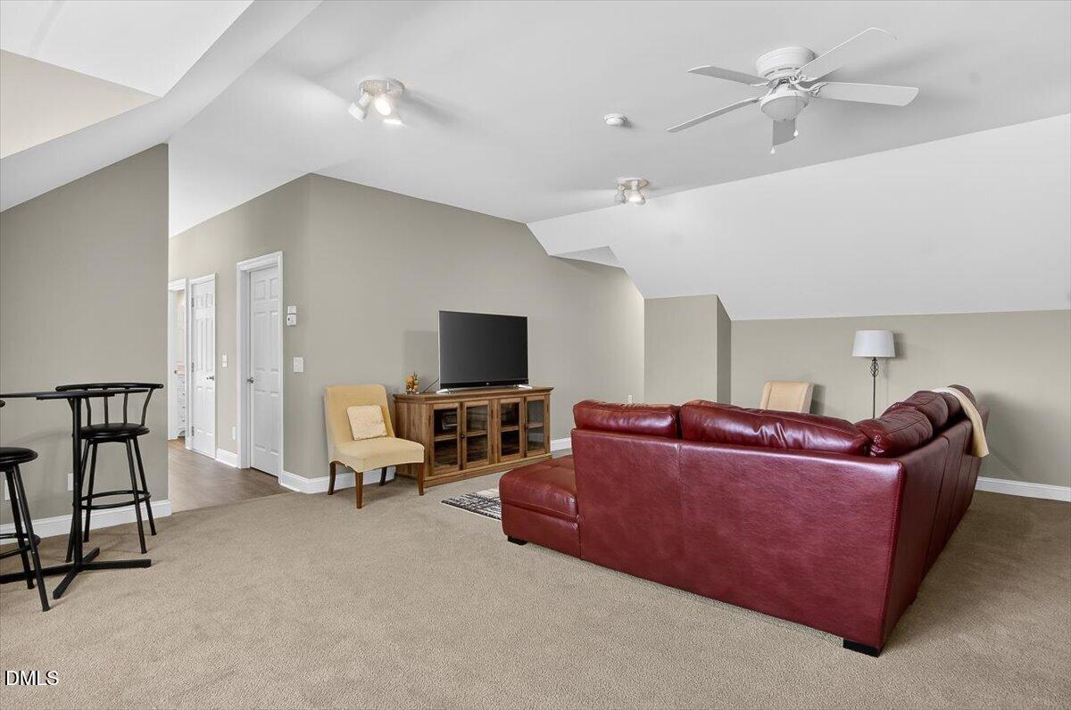 185 Joe Baldwin Road Leasburg, NC 27291 - Photo 46 of 95 a living room with furniture and a flat screen tv