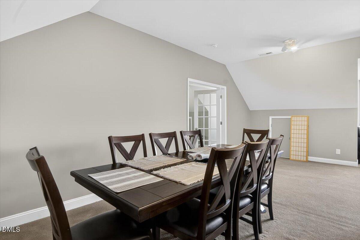 185 Joe Baldwin Road Leasburg, NC 27291 - Photo 50 of 95 a view of a dining room with furniture and wooden floor