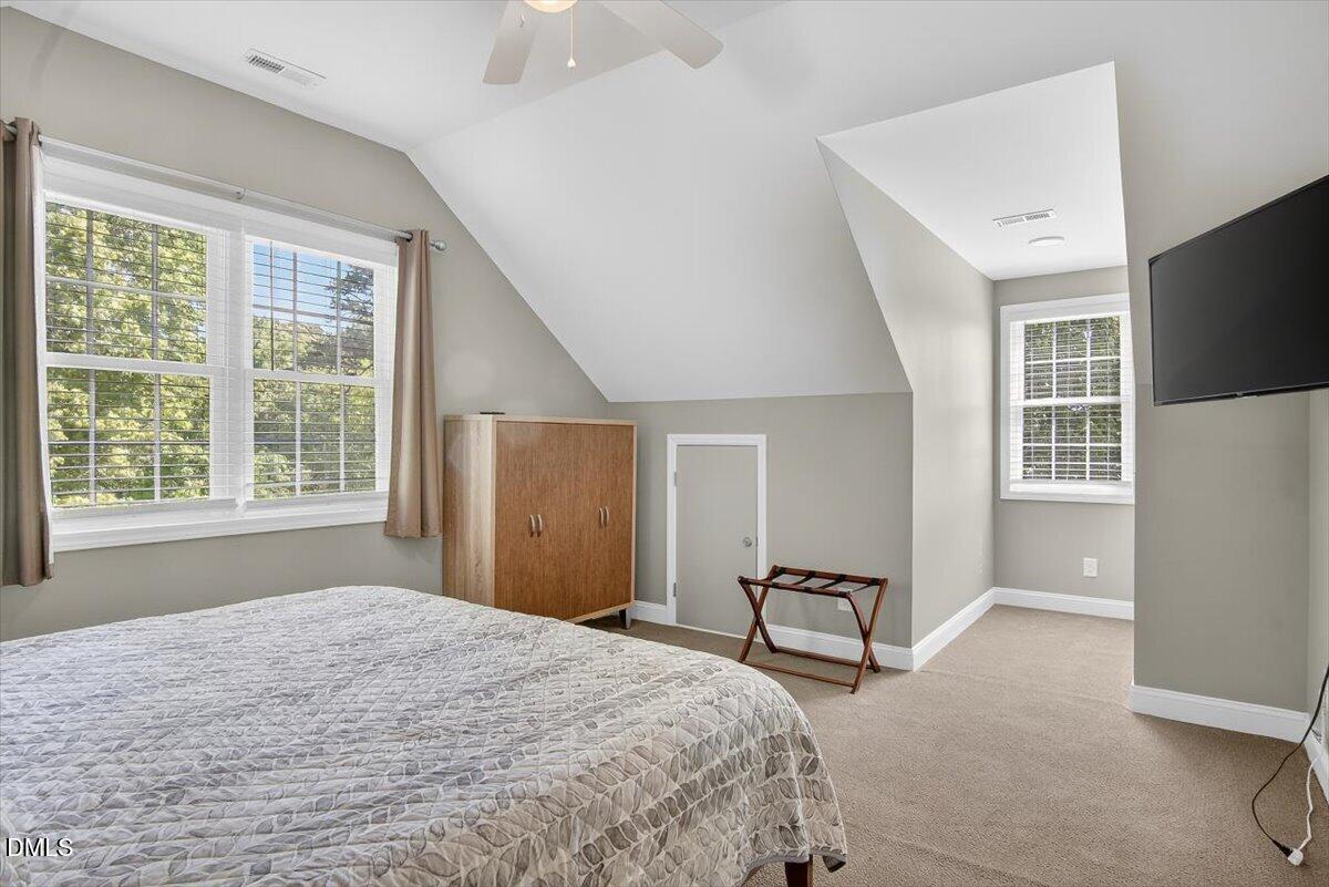 185 Joe Baldwin Road Leasburg, NC 27291 - Photo 55 of 95 a spacious bedroom with a bed and a large window