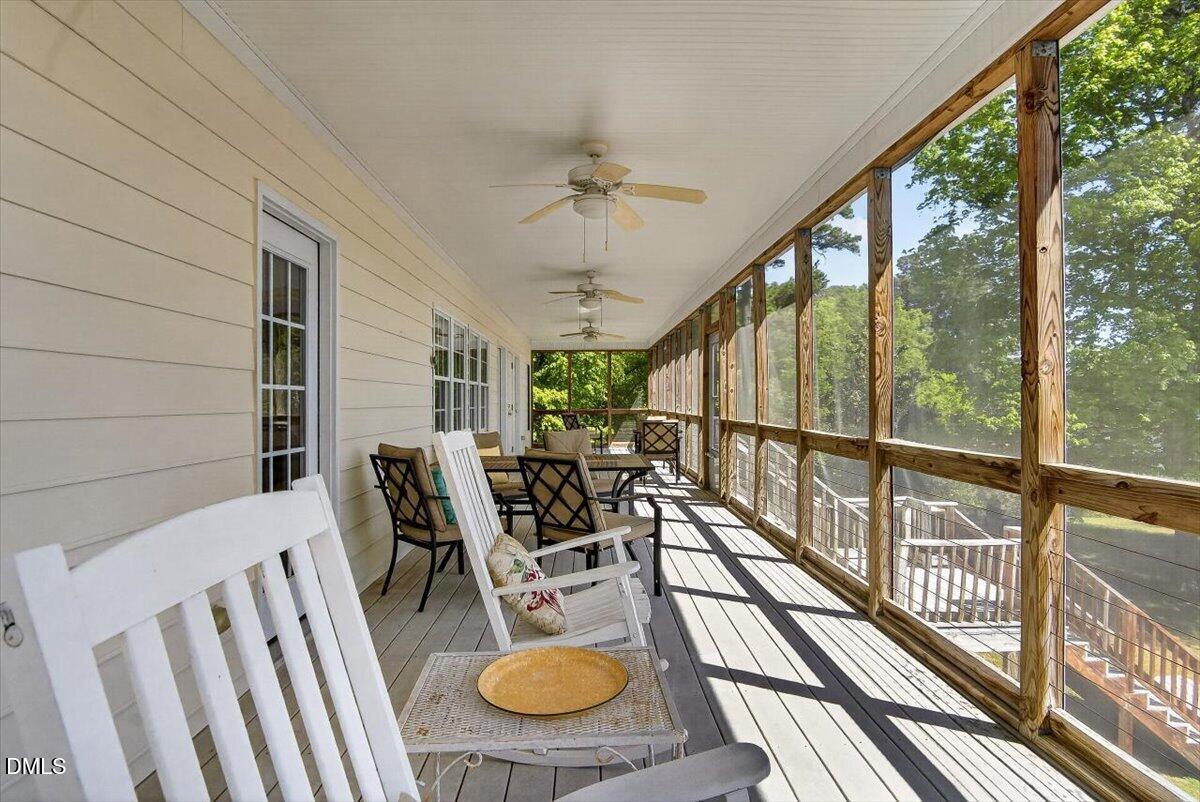 185 Joe Baldwin Road Leasburg, NC 27291 - Photo 62 of 95 a view of a dining room with furniture water view and wooden floor