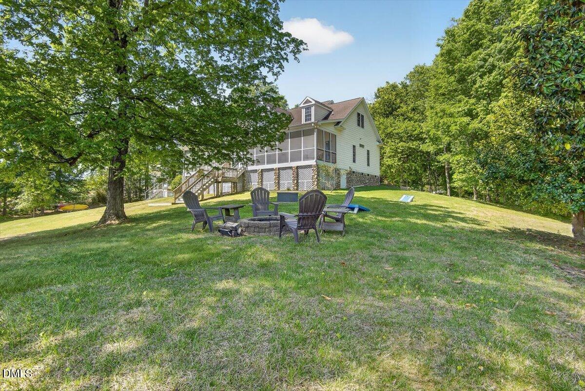185 Joe Baldwin Road Leasburg, NC 27291 - Photo 67 of 95 a view of a house with a backyard porch and sitting area