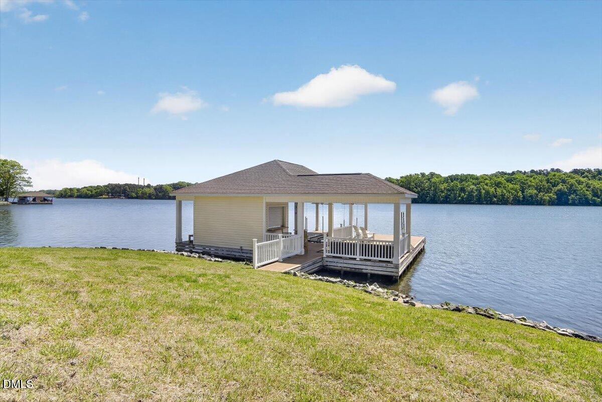 185 Joe Baldwin Road Leasburg, NC 27291 - Photo 4 of 95 a view of a house with a yard and a lake view