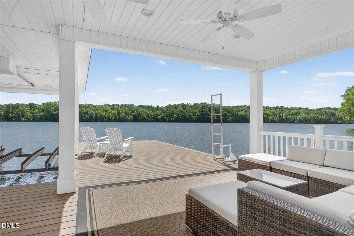 185 Joe Baldwin Road Leasburg, NC 27291 - Photo 69 of 95 a view of a patio with couches chairs and wooden floor