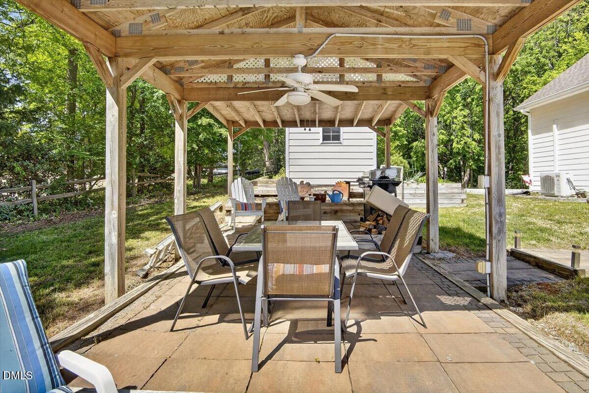 185 Joe Baldwin Road Leasburg, NC 27291 - Photo 84 of 95 a view of a patio with a table chairs and a floor to ceiling window