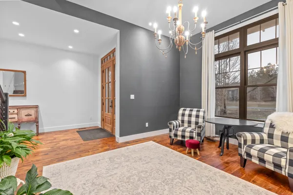 a living room with fireplace furniture and a large window