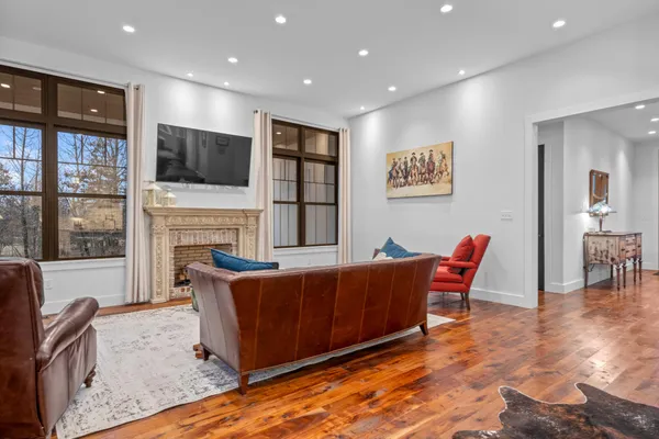 a bedroom with a bed painting and a large window