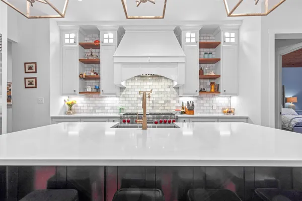 a living room with furniture a flat screen tv and a floor to ceiling window