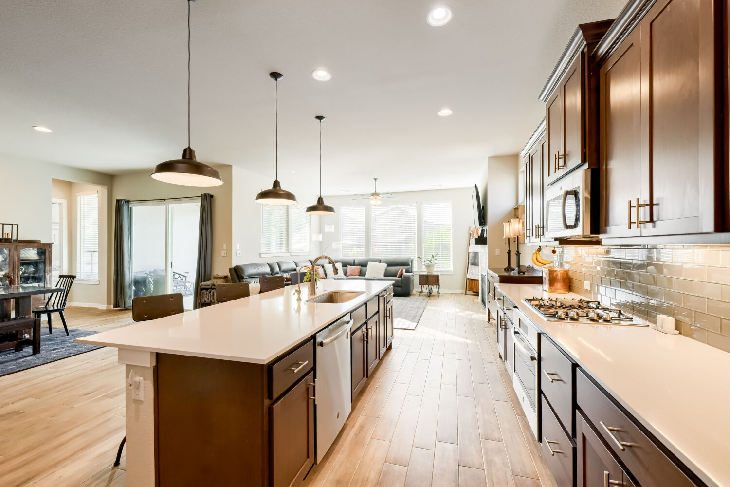 621 Rancho Sienna Loop Georgetown, TX 78628 - Photo 8 of 28 The open-concept kitchen and living area feature wood flooring and abundant natural light.
