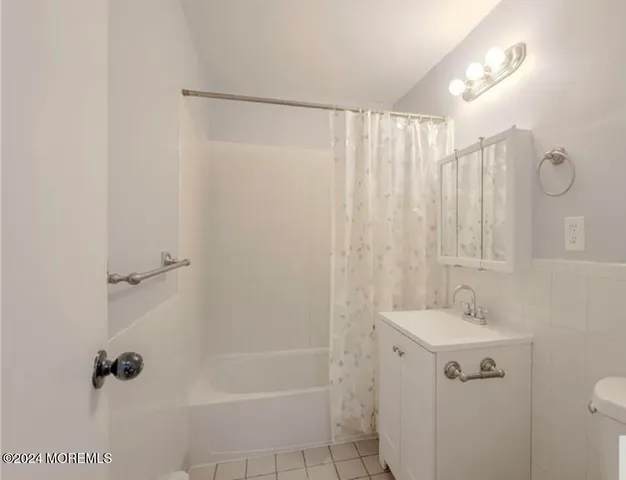 a bathroom with a shower curtain and a sink